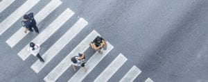 From the top view of people walk on street pedestrian crossroad in the city street with the motorcycle drives pass road ,bird eye view.